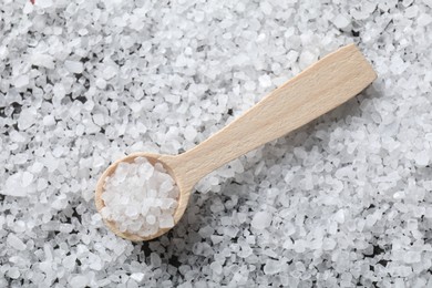 Photo of Natural salt and wooden spoon, top view