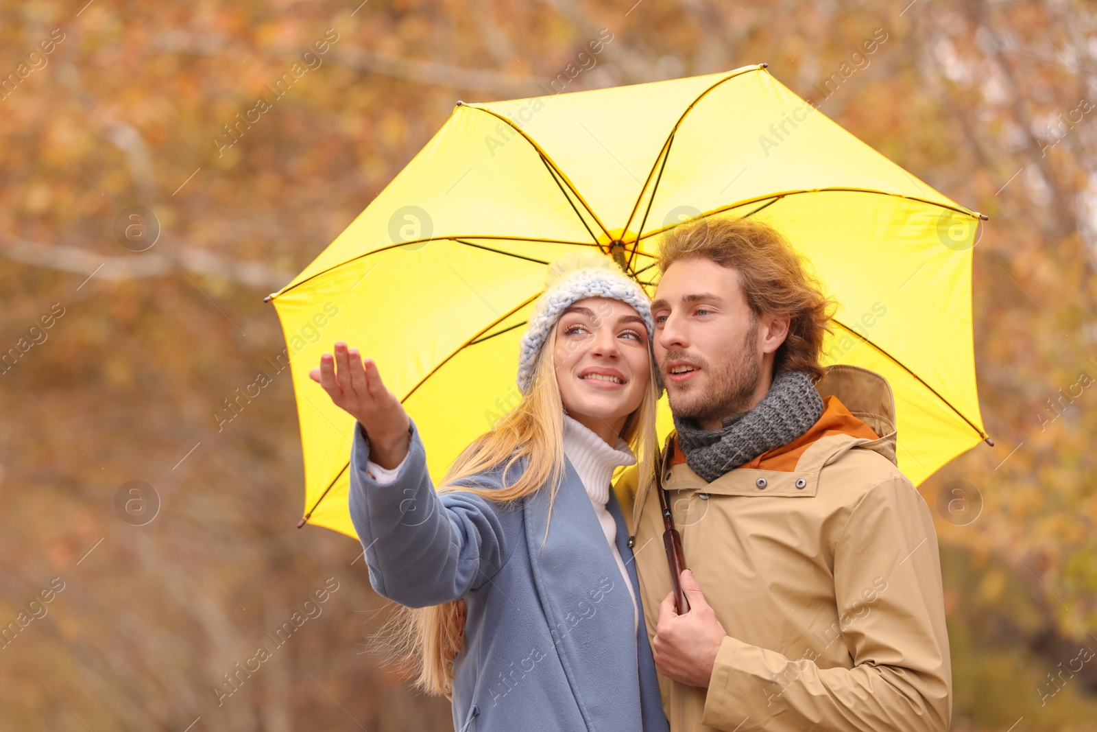 Photo of Romantic couple with umbrella in park on autumn day