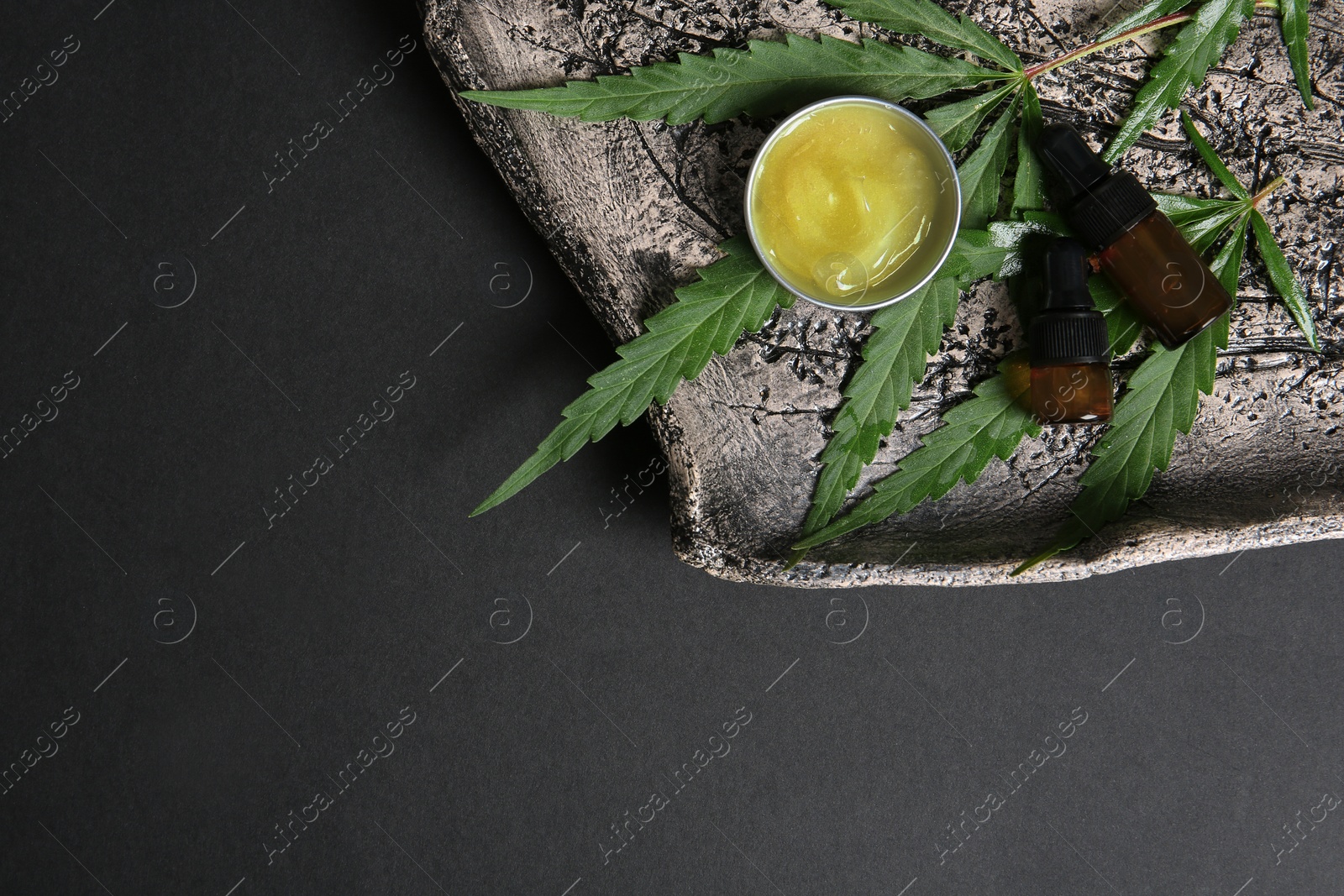 Photo of Flat lay composition with hemp lotion and space for text on black background