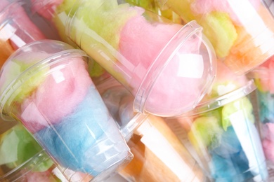 Photo of Pile of plastic cups with cotton candies, closeup