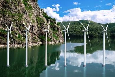 Image of Floating wind turbines installed in water near mountains. Alternative energy source