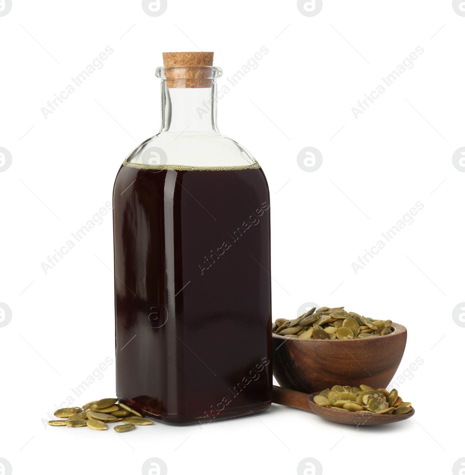 Photo of Vegetable fats. Pumpkin seed oil in glass bottle and seeds isolated on white