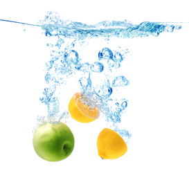 Photo of Apple and lemon falling down into clear water against white background