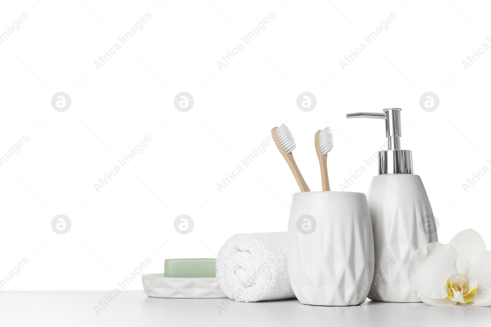 Photo of Bath accessories. Different personal care products and flower on table against white background. Space for text