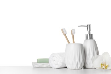 Photo of Bath accessories. Different personal care products and flower on table against white background. Space for text