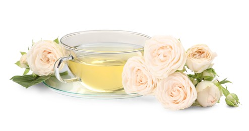 Aromatic herbal tea in glass cup and roses isolated on white