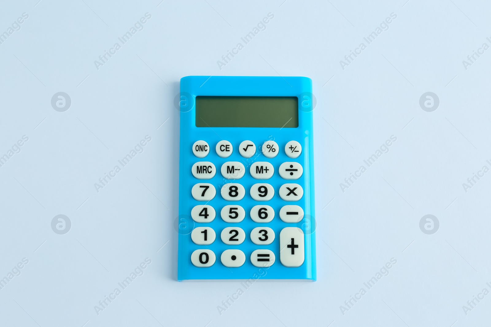 Photo of Light blue calculator on white background, top view