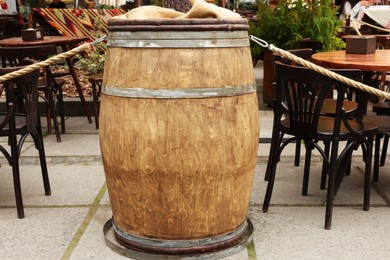 Photo of Traditional wooden barrel near street cafe outdoors