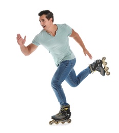Handsome young man with inline roller skates on white background
