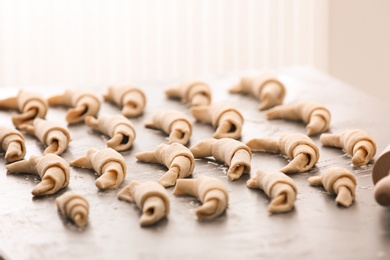 Photo of Raw croissants on grey table