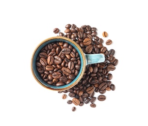 Photo of Cup and roasted coffee beans on white background, top view