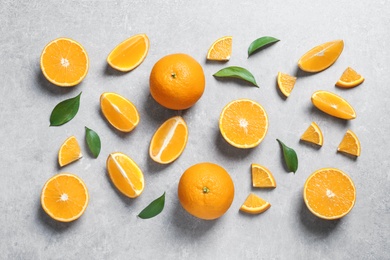 Flat lay composition with fresh oranges on grey background