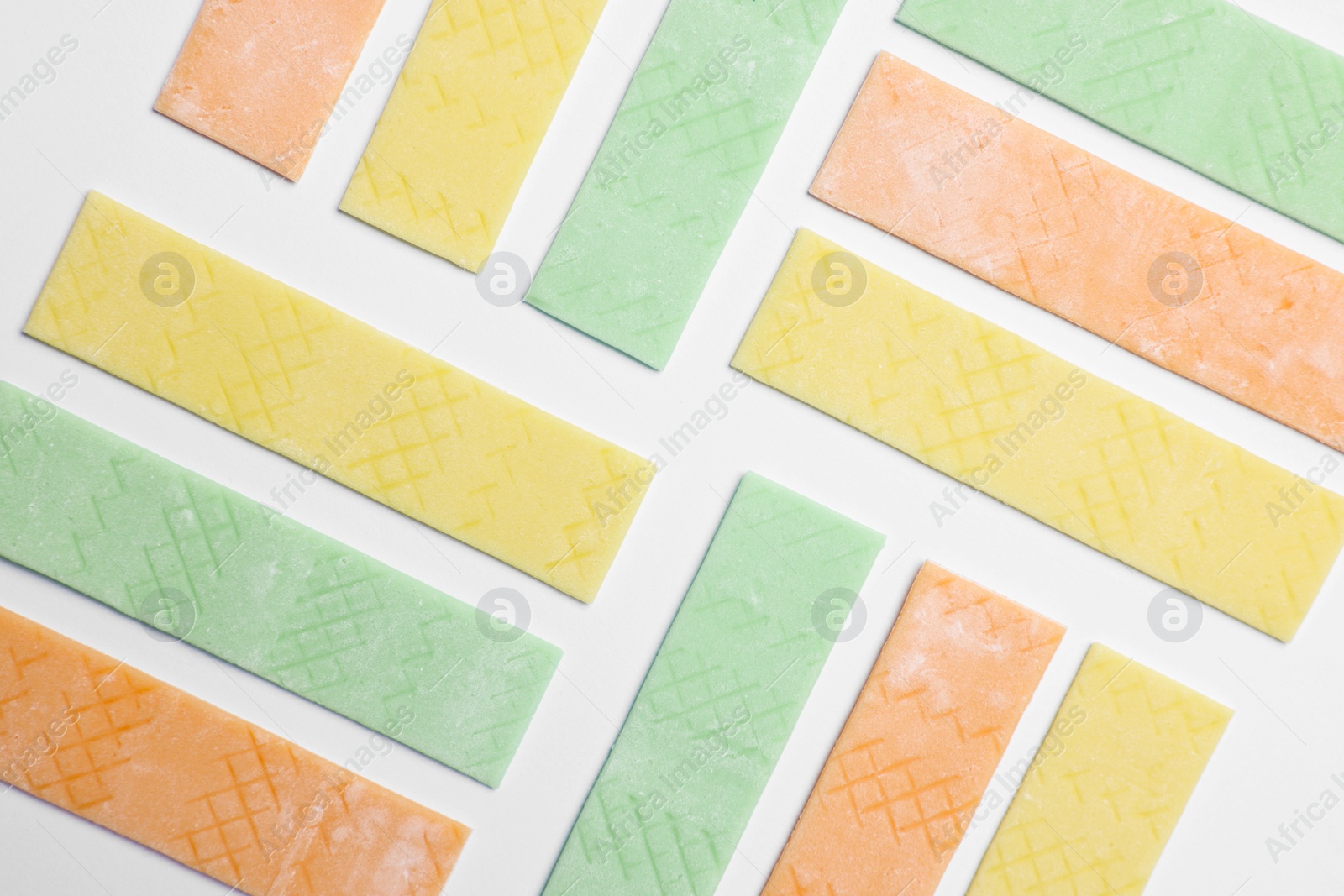 Photo of Sticks of tasty bubble gums on white background, flat lay