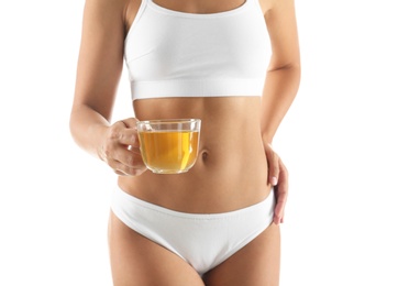 Young woman holding cup of diet tea on white background, closeup