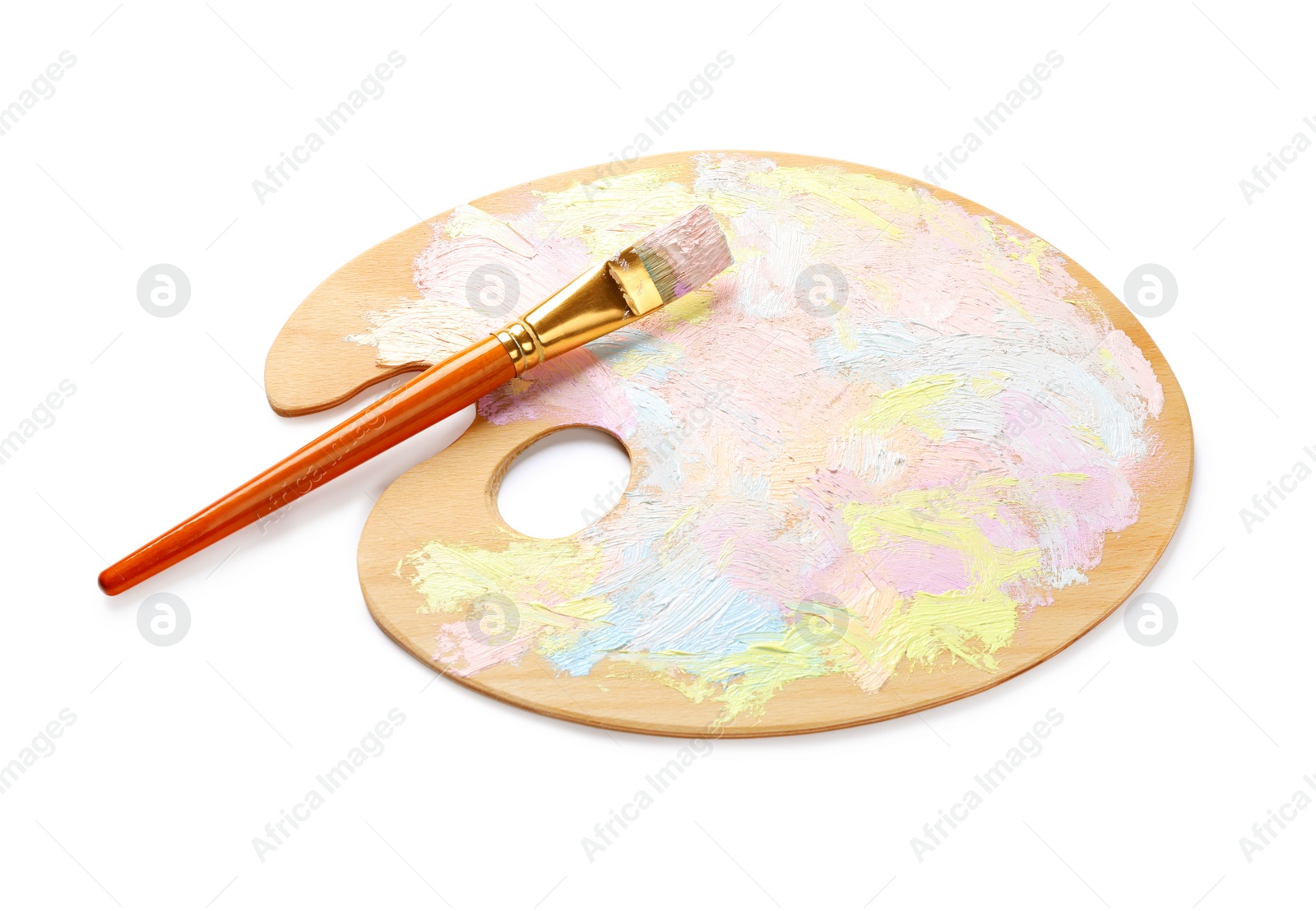 Photo of Wooden artist's palette with mixed pastel paints and brush isolated on white