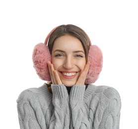 Happy woman wearing warm earmuffs on white background