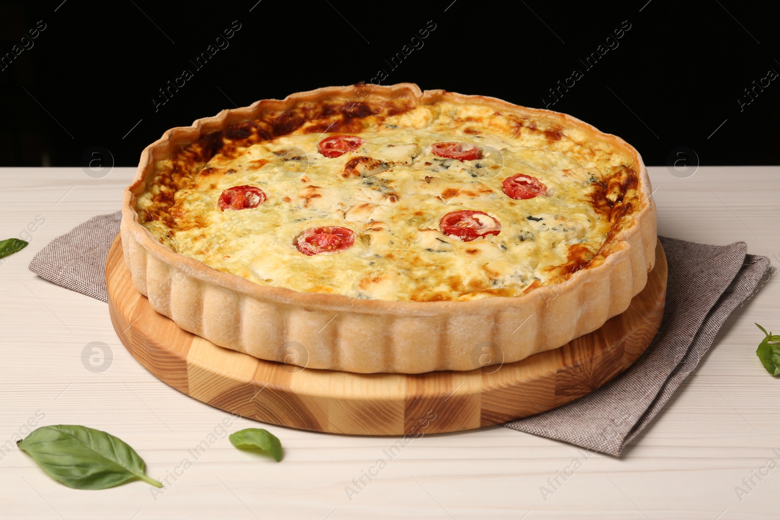 Photo of Delicious homemade cheese quiche on white table