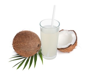 Glass of coconut water, leaf and nuts isolated on white