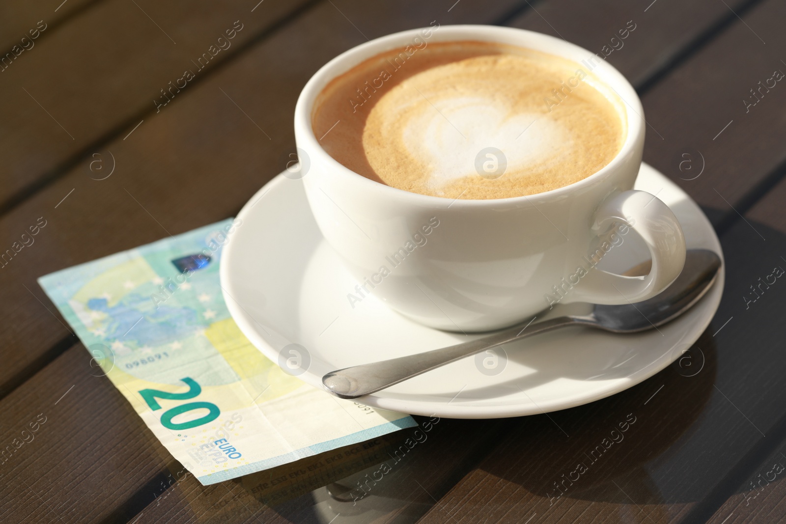 Photo of Tasty hot coffee and payment for order on table, closeup. Leave tip