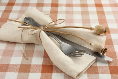 Photo of Stylish setting with cutlery and napkin on table, closeup