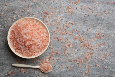 Pink himalayan salt on grey table, flat lay