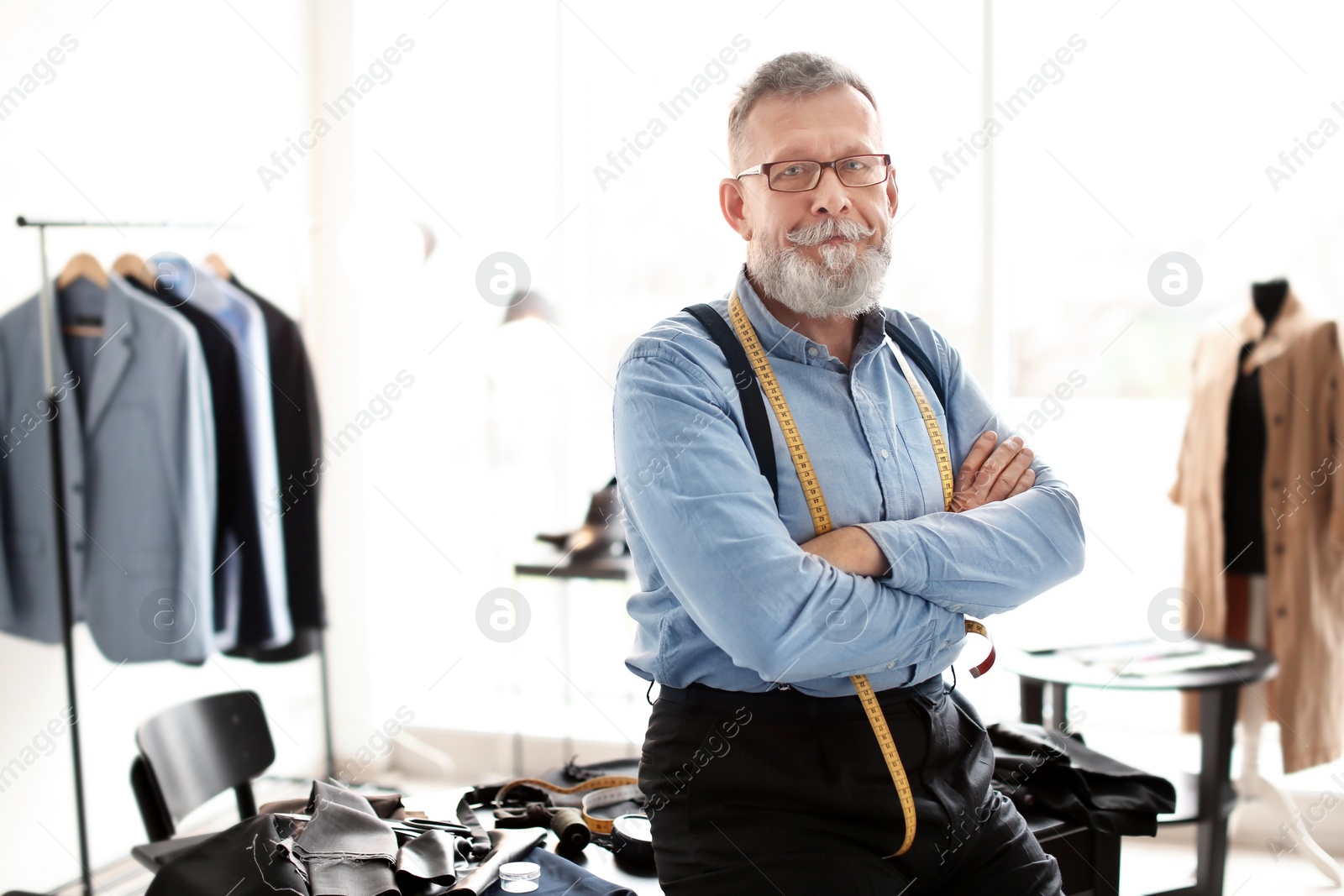 Photo of Portrait of mature tailor in atelier