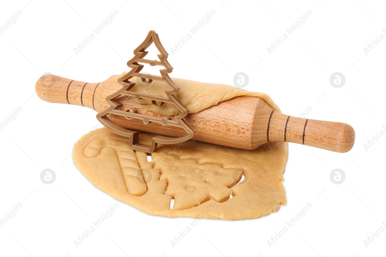 Photo of Cookie cutter in shape of Christmas tree, dough and rolling pin isolated on white