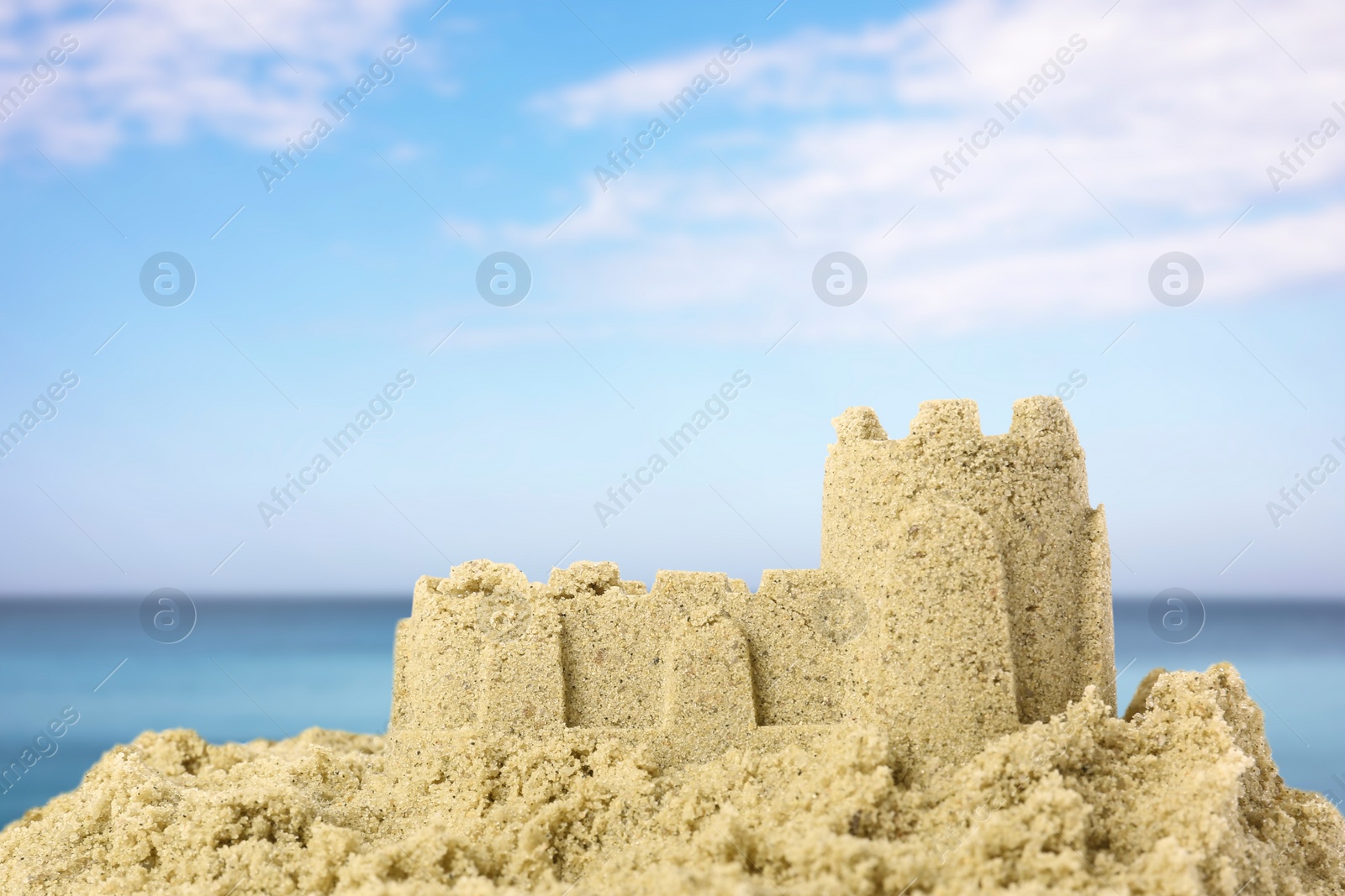 Image of Sand castle on ocean beach, closeup. Outdoor play