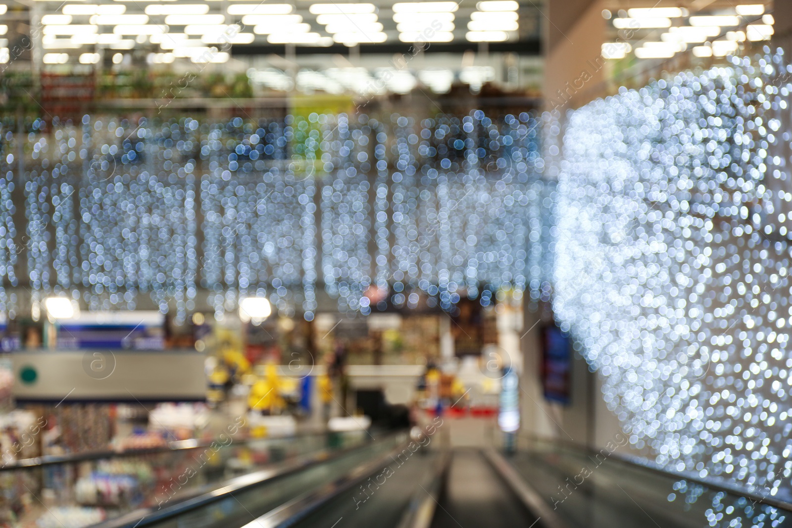 Photo of Blurred view of shopping mall interior decorated for Christmas. Bokeh effect