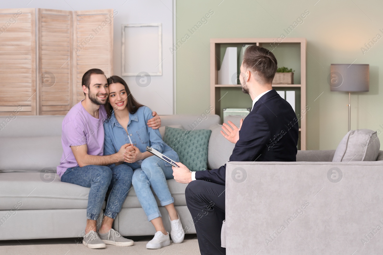 Photo of Family psychologist working with young couple in office