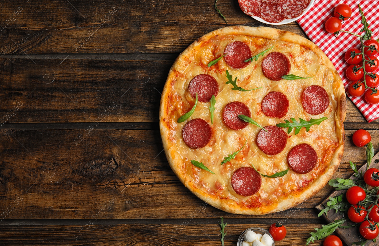 Photo of Flat lay composition with tasty pepperoni pizza on wooden table. Space for text