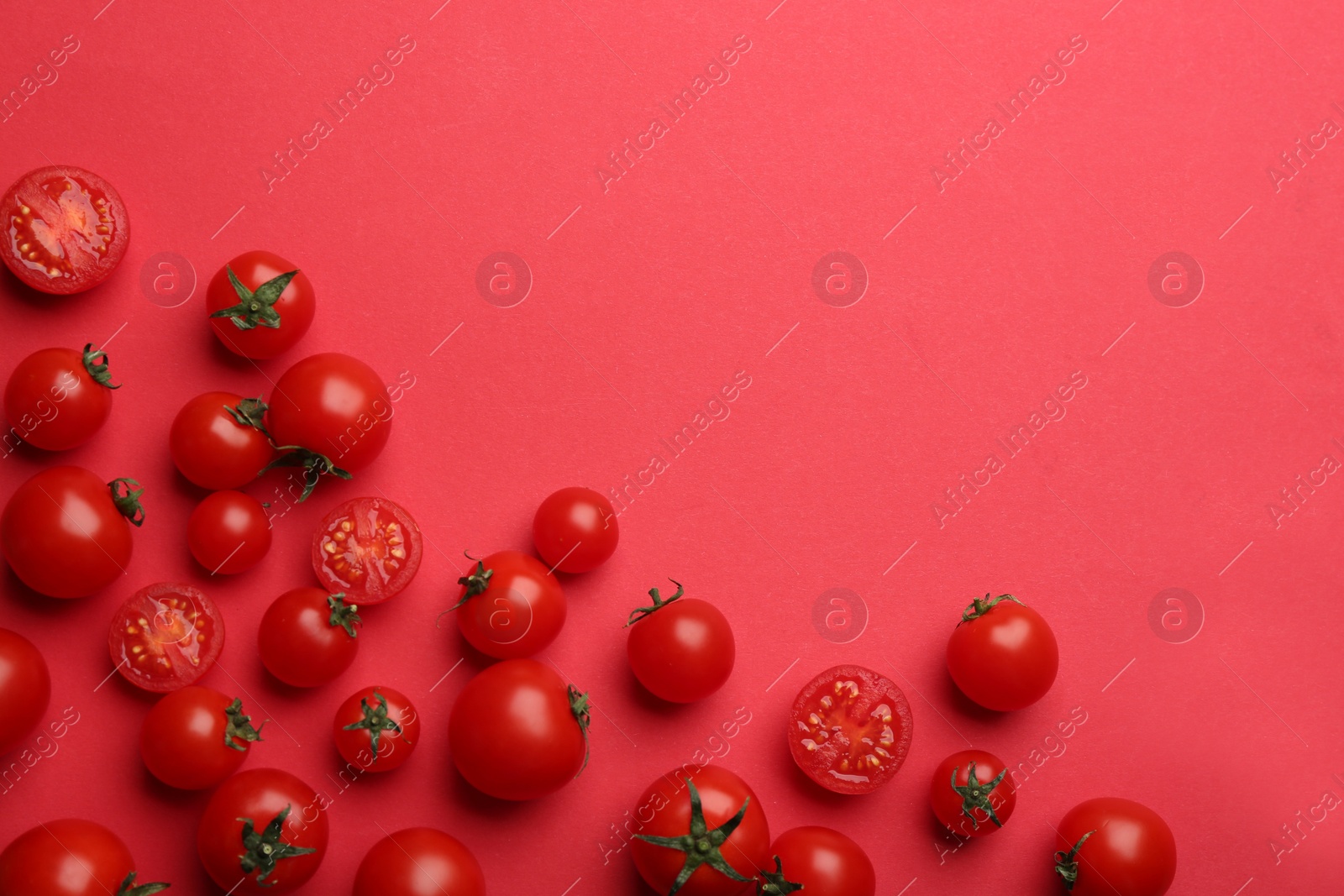 Photo of Fresh cherry tomatoes on red background, flat lay. Space for text