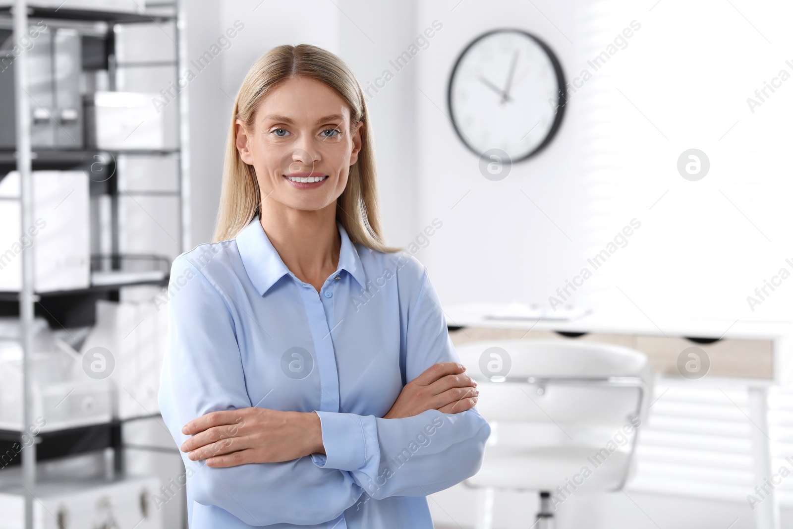 Photo of Portrait of beautiful woman in formal clothes indoors. Space for text. Confident lady with blonde hair looking into camera