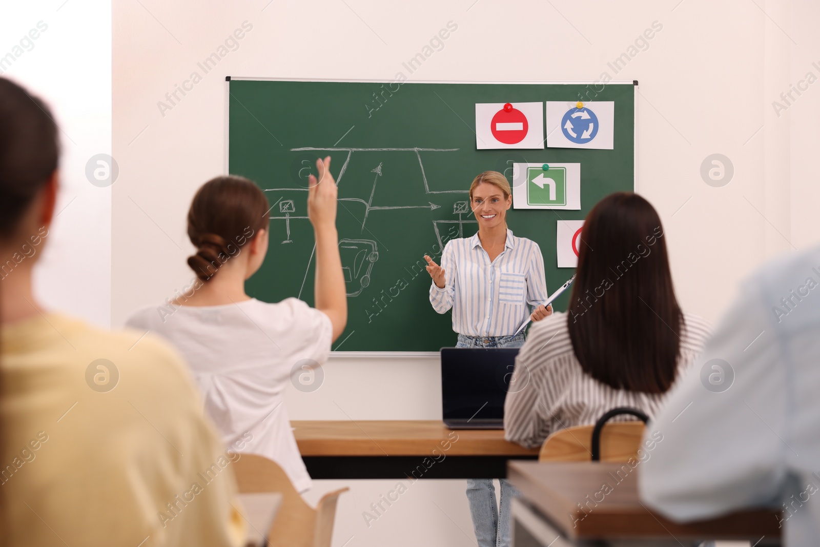 Photo of Teacher giving lesson to audience in driving school