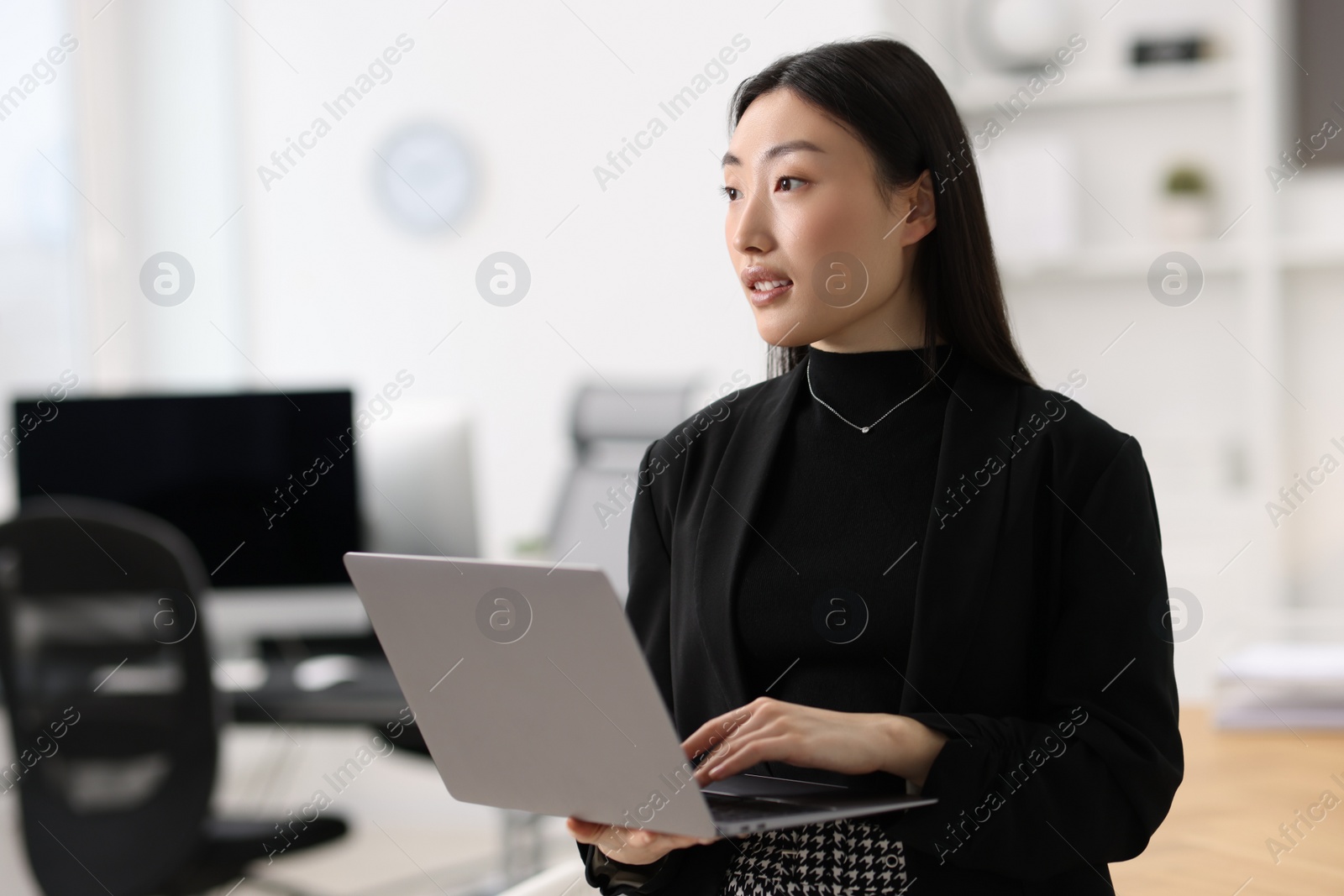 Photo of Portrait of smiling businesswoman with laptop in office. Space for text