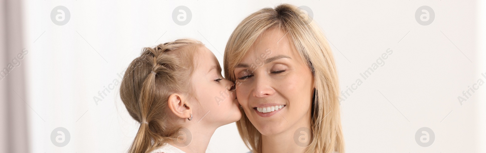 Image of Mother and her little daughter spending time together at home, banner design