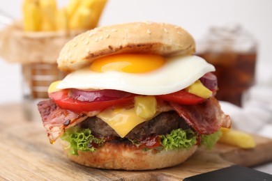 Photo of Delicious burger with fried egg on table, closeup