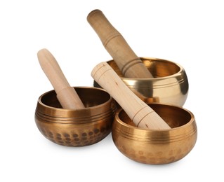 Photo of Tibetan singing bowls and wooden mallets on white background
