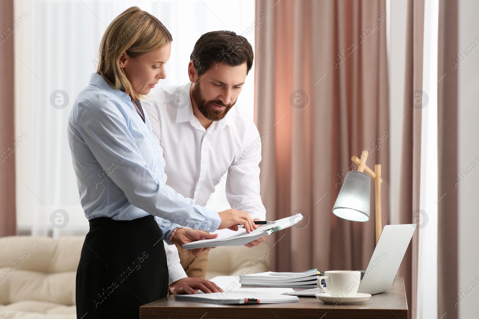 Photo of Businesspeople working with documents in modern office