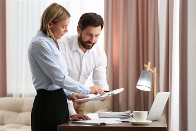 Businesspeople working with documents in modern office