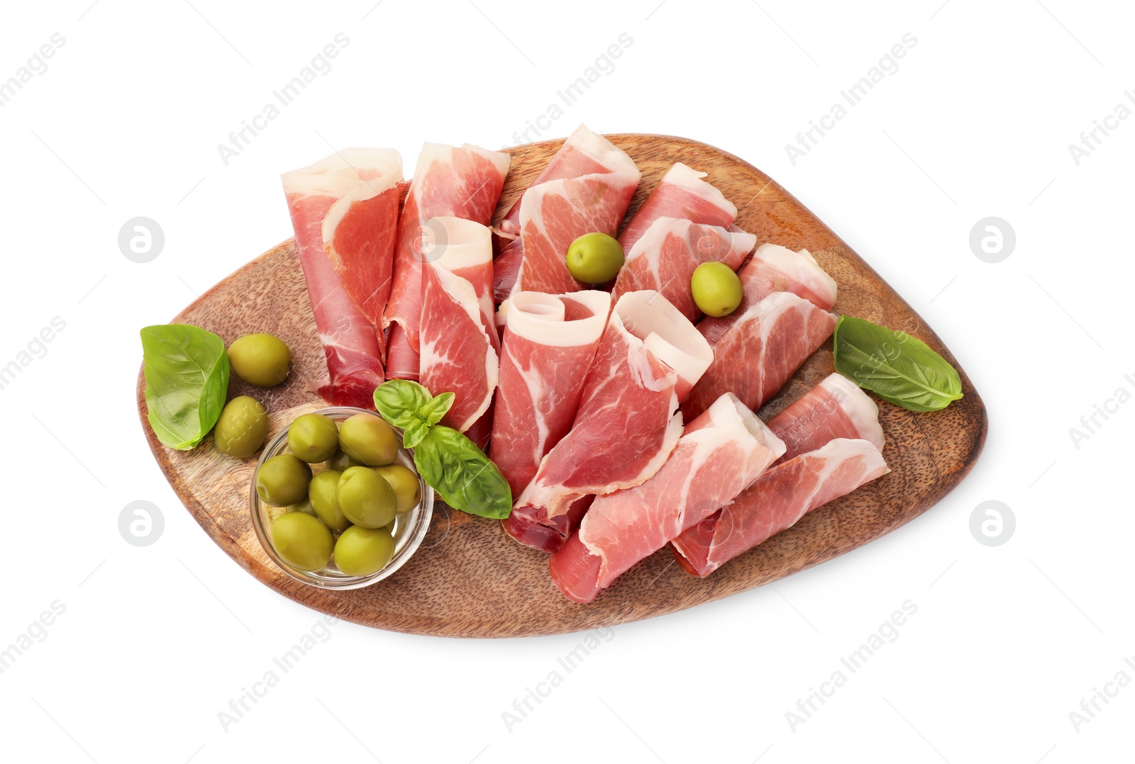 Photo of Wooden board with rolled slices of delicious jamon, olives and basil isolated on white, top view