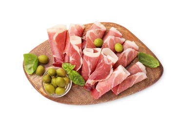 Photo of Wooden board with rolled slices of delicious jamon, olives and basil isolated on white, top view