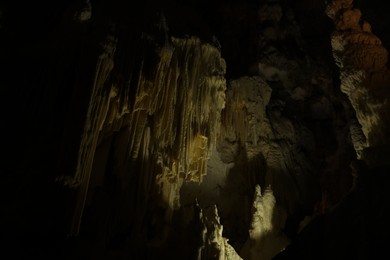 Many stalactite and stalagmite formations inside cave