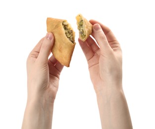 Photo of Woman holding fresh cut samosa on white background, closeup