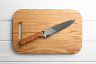 Photo of One sharp knife and board on white wooden table, top view