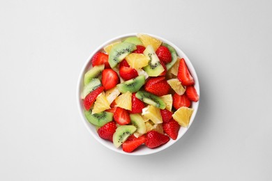 Photo of Yummy fruit salad in bowl on light grey background, top view