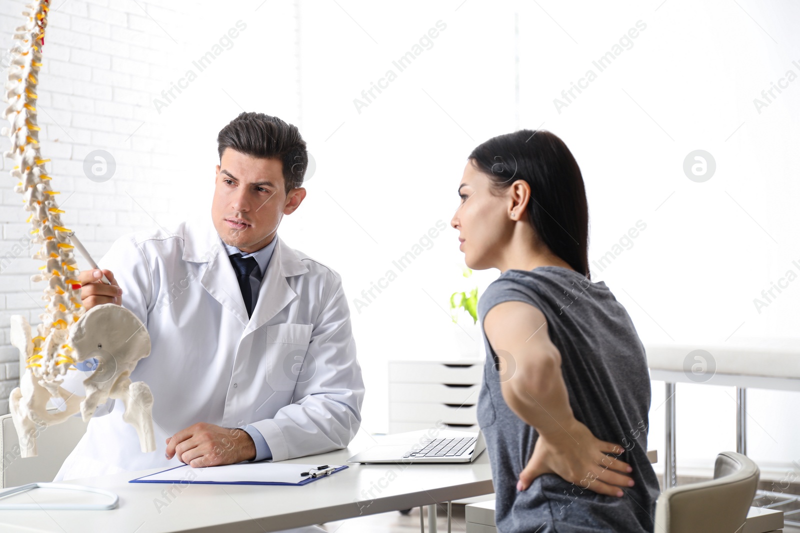 Photo of Young woman visiting orthopedist in medical office