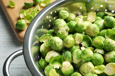 Tasty Brussels sprouts in colander on table, closeup