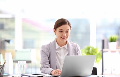 Photo of Consultant working at table in office