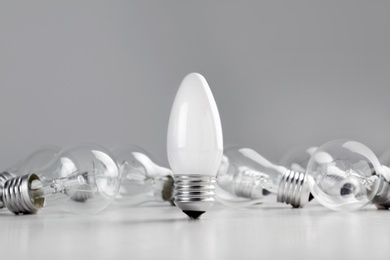 Frosted and transparent lamp bulbs on table